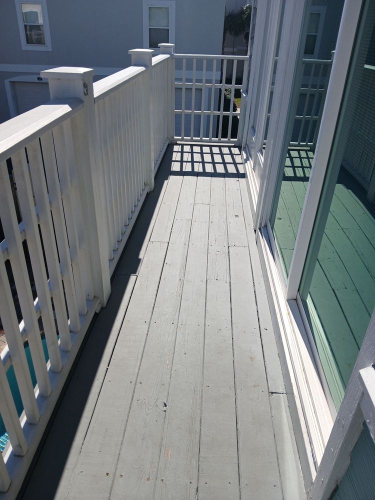 Painted balcony deck — gray planks, white spindle railing